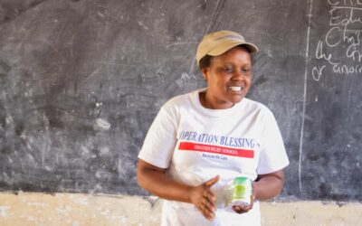 An OB worker teaching villagers in Kenya about fighting Malaria.