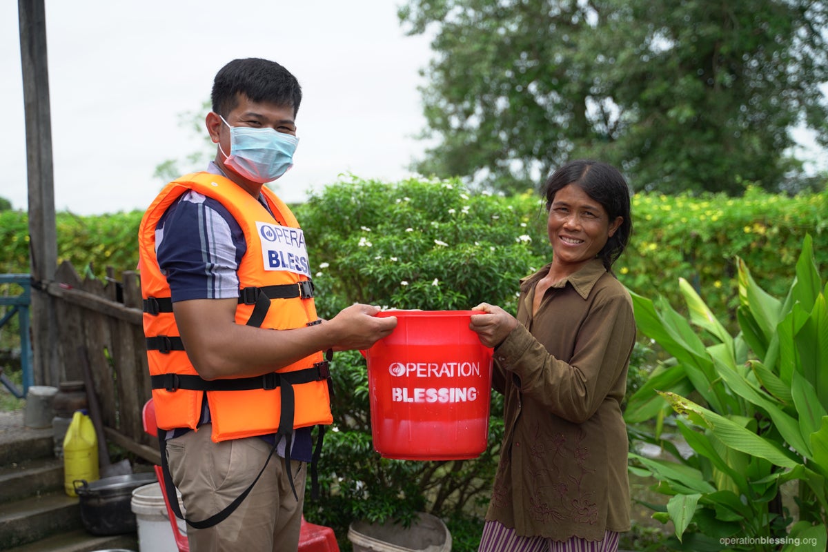 Woman receives Cambodia flood relief.