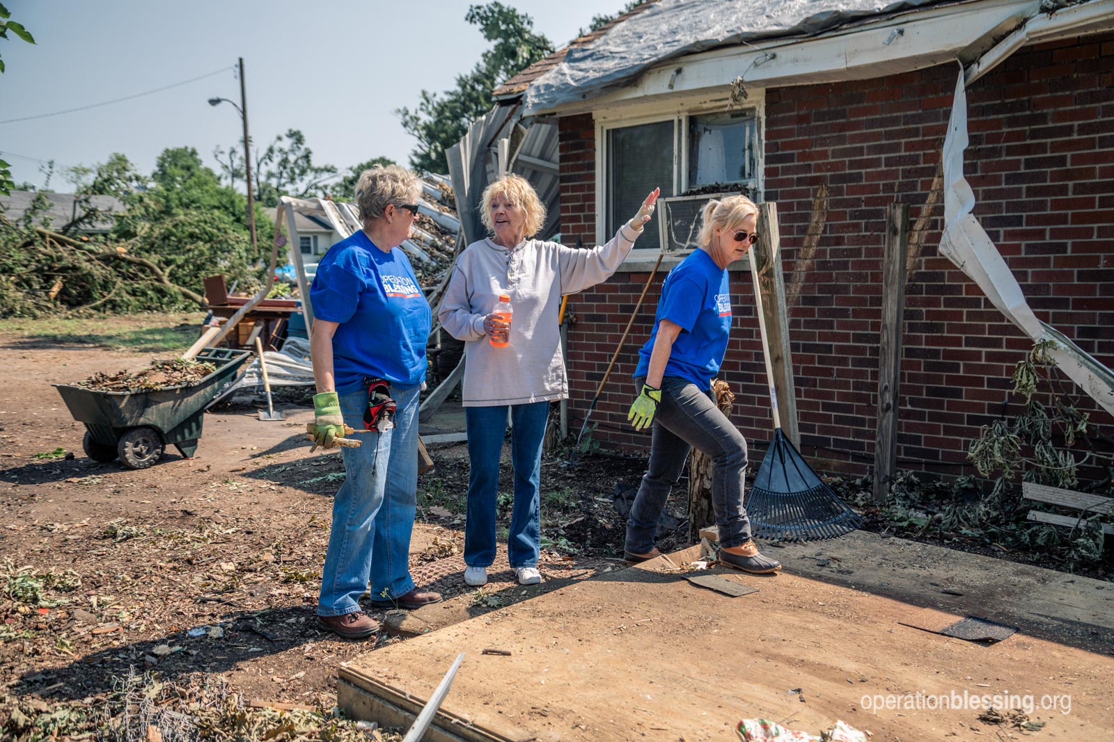 Anita pointing to the damage to her house.