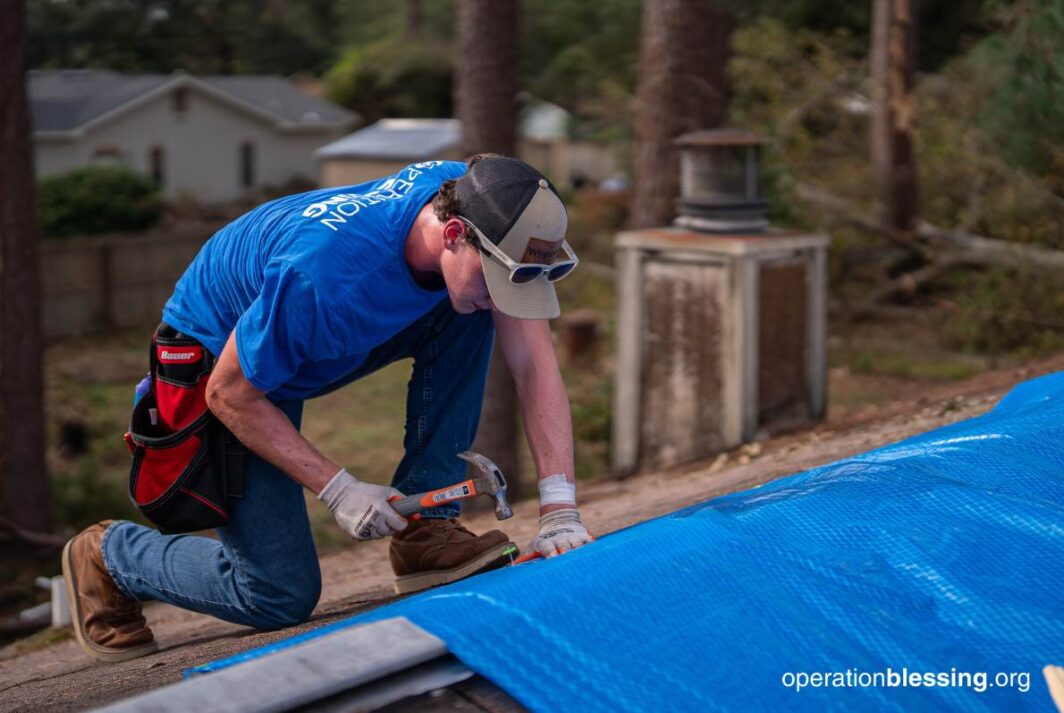 tarping a roof after the hurricane