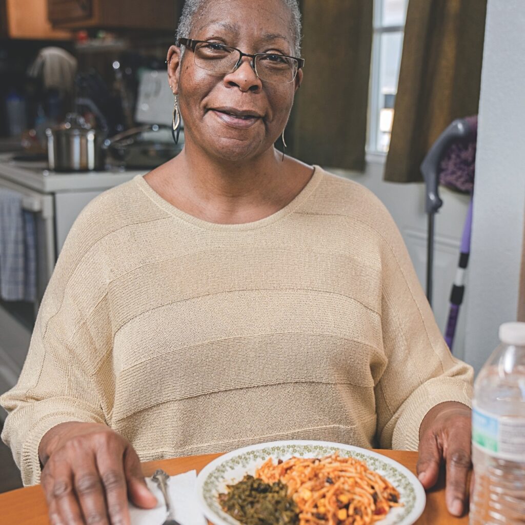 A woman reflecting with gratitude after receiving food assistance from a faith-based community program